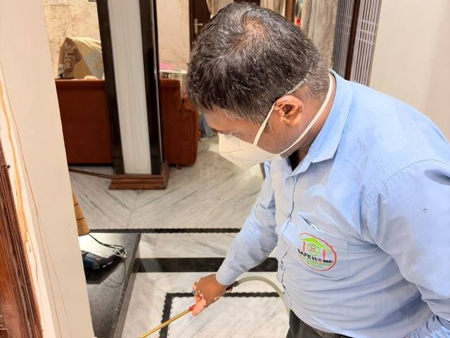 Post-construction termite treatment at a floor junction